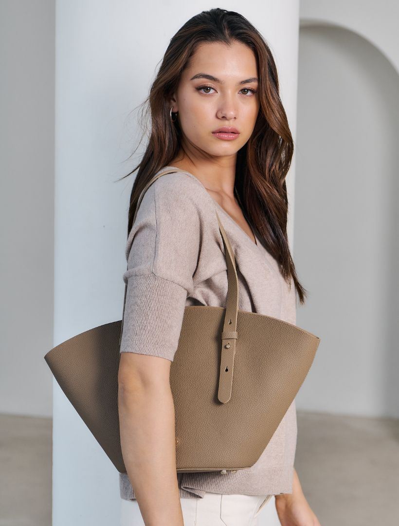 Model wears Zjoosh pecan  leather tote