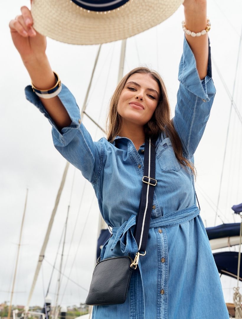 A woman wearing Zjoosh navy cross body bag