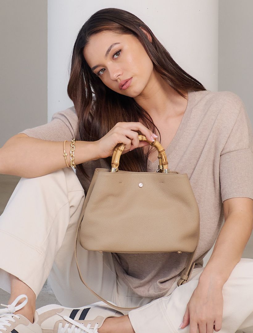 Model wearing Zjoosh bamboo handle leather bag