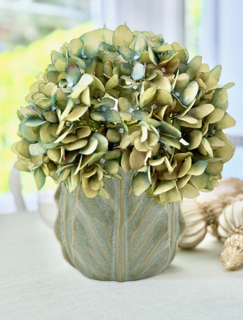 Faux flower in green cabbage ceramic pot