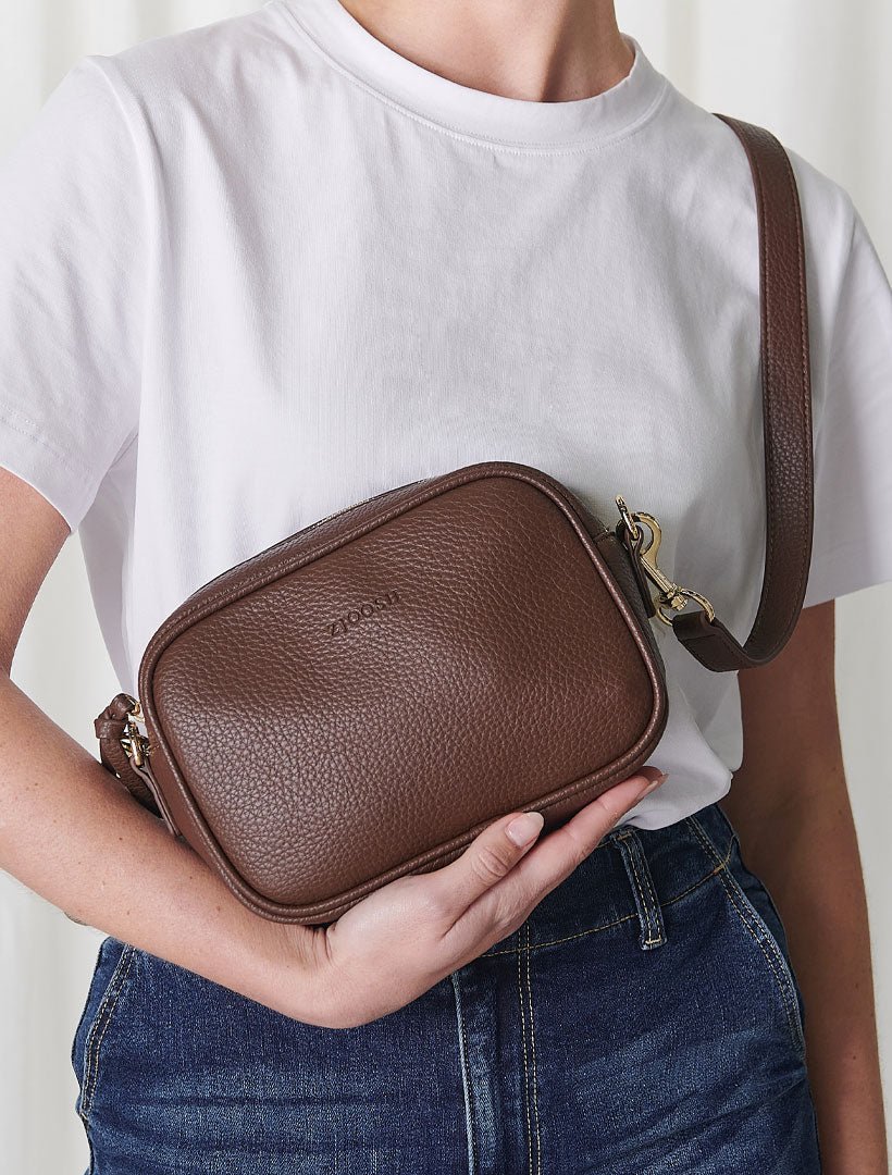 model holding chocolate cross body bag from zjoosh