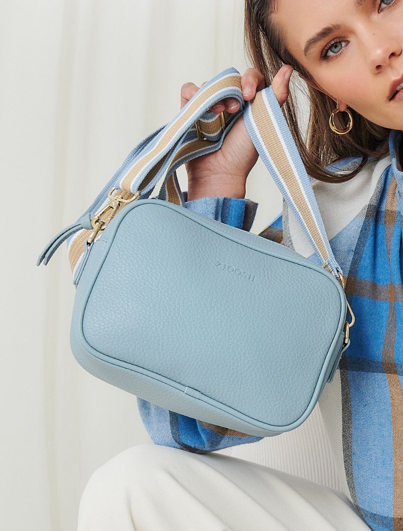 model holding dusty blue cross body bag from zjoosh