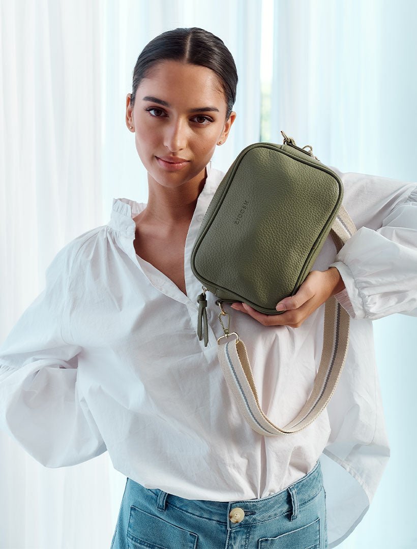 model holding khaki cross body bag from zjoosh