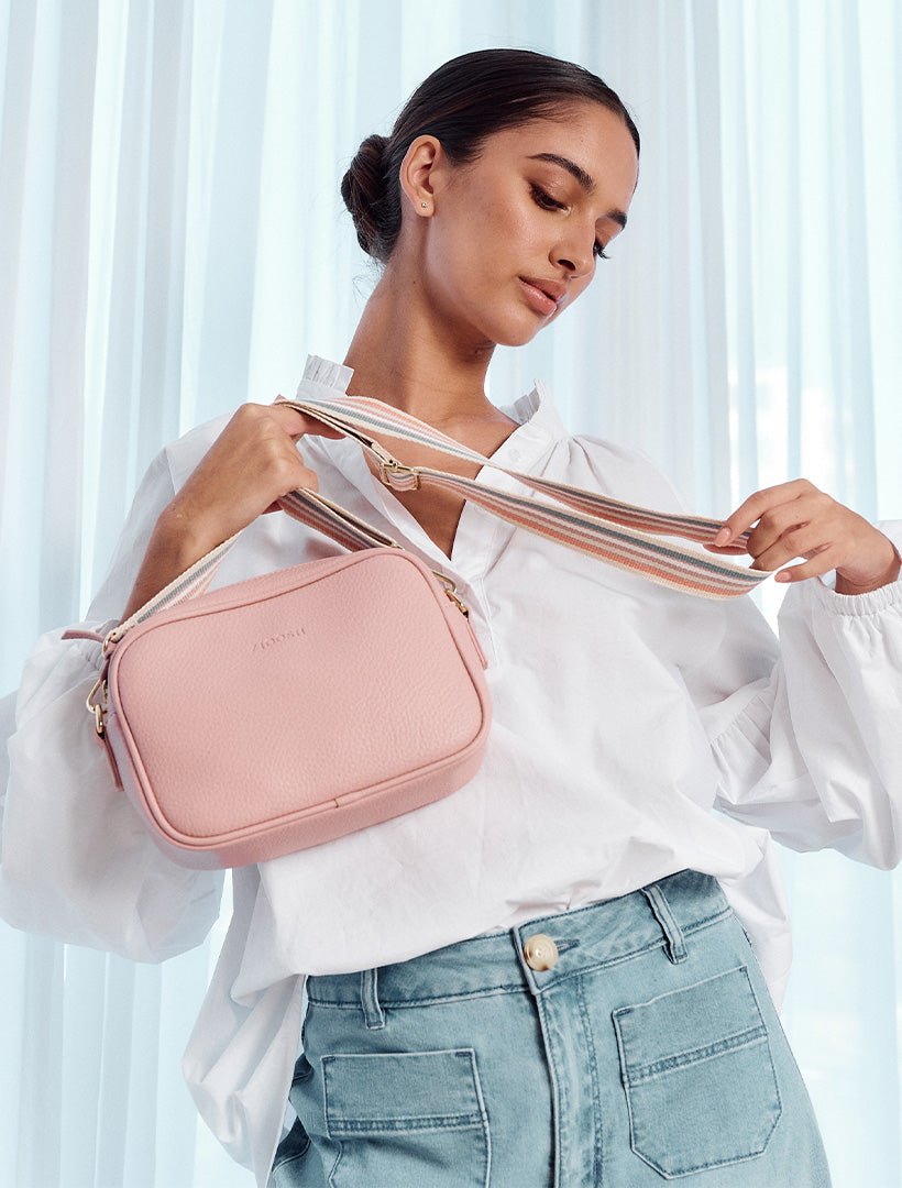 model holding pink cross body bag from zjoosh