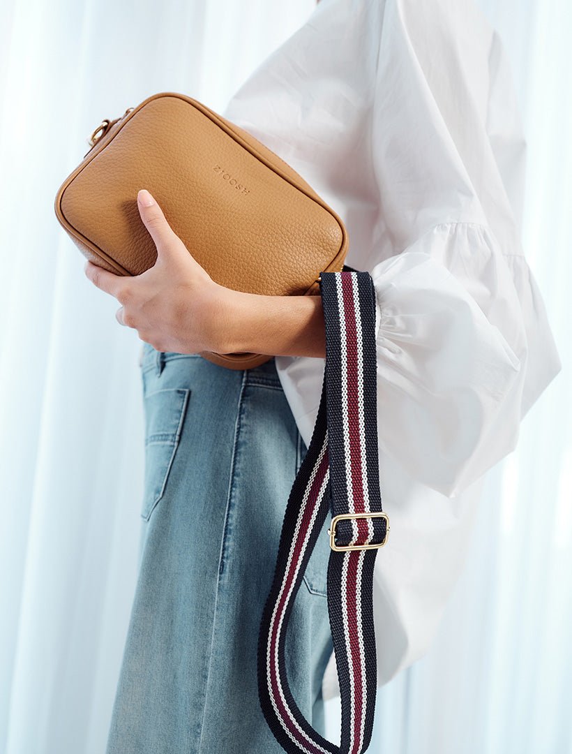 model holding tan cross body bag from zjoosh