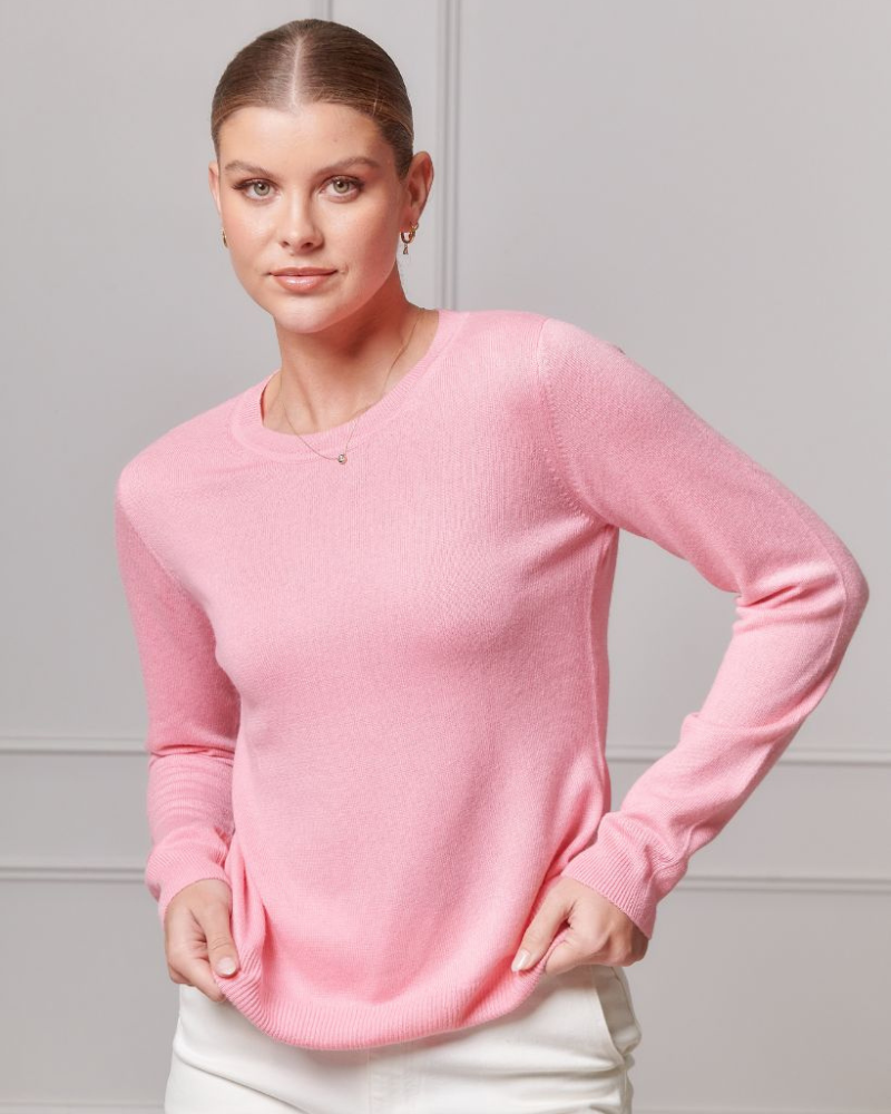 girl wearing pink jumper on sale