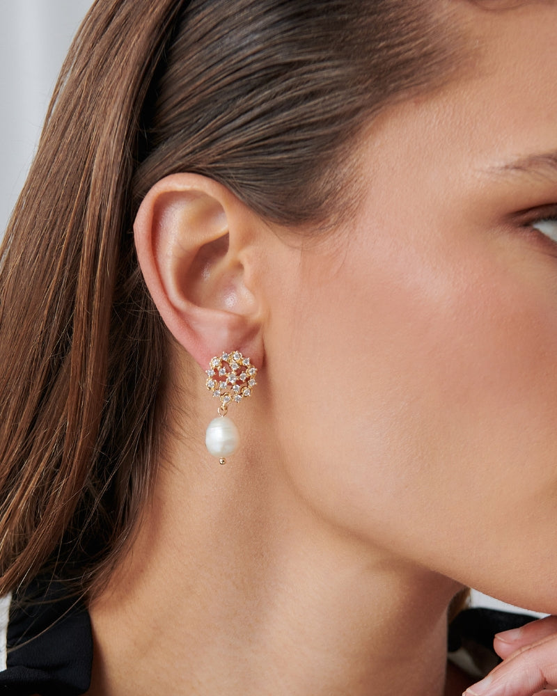 model wearing crystal earrings with a pearl drop